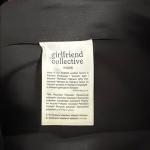 girlfriend collective black activewear leggings with care label visible.